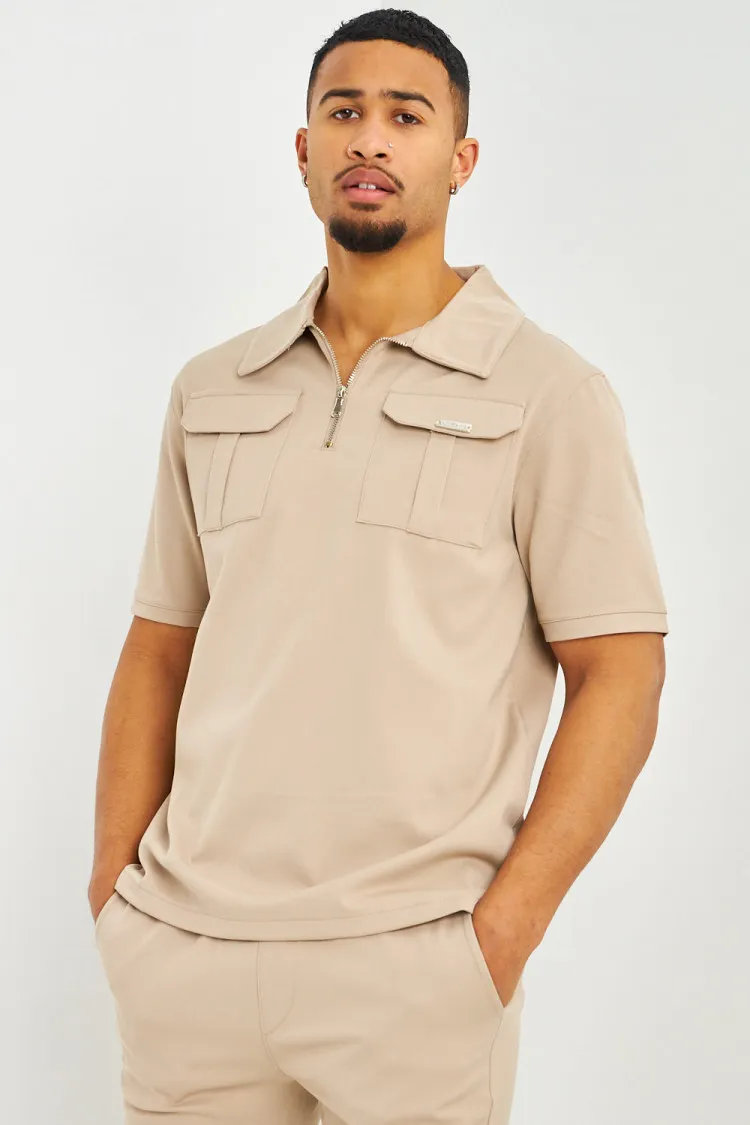 Polo uni beige col zippé à poches