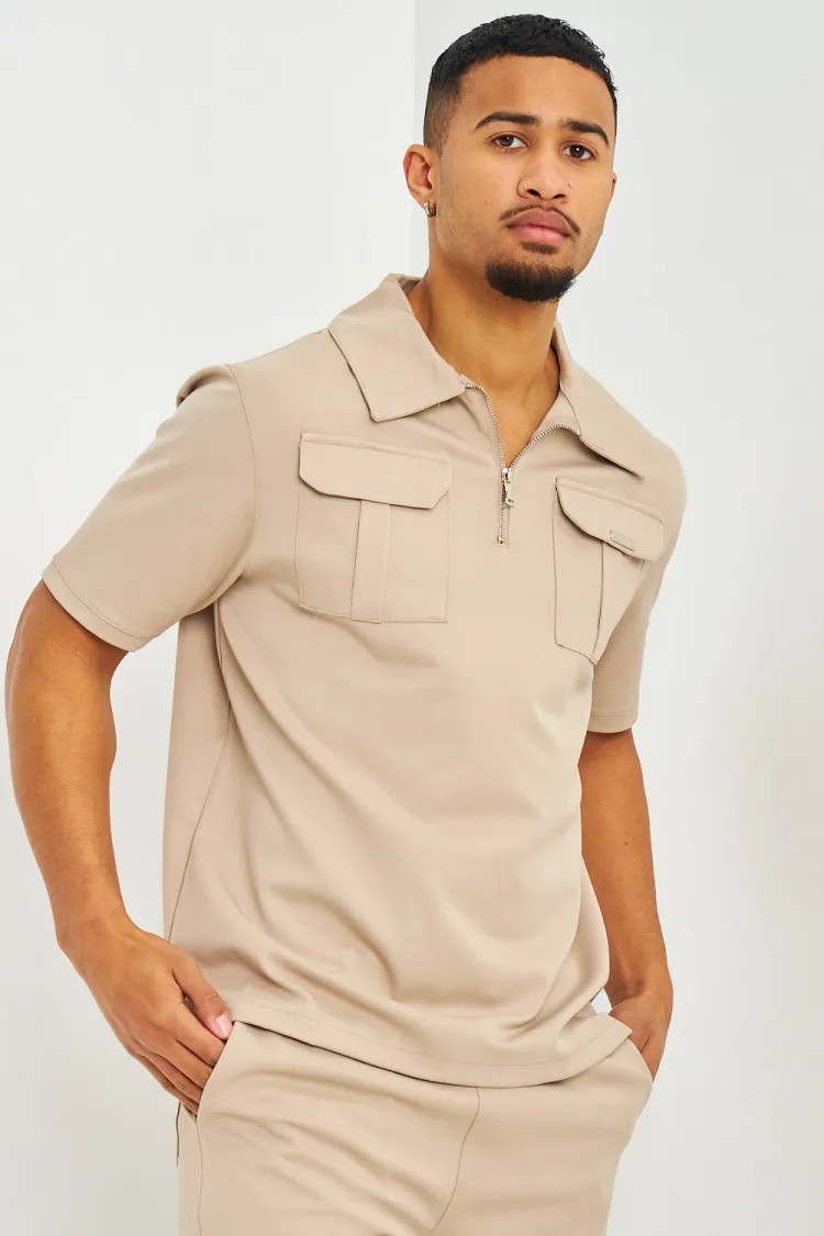 Polo uni beige col zippé à poches